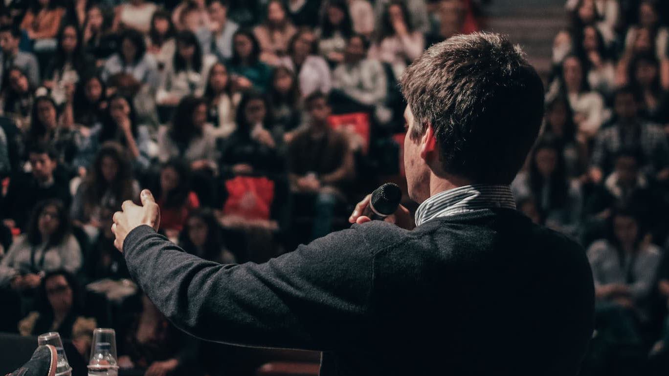 Person giving a lecture in large hall