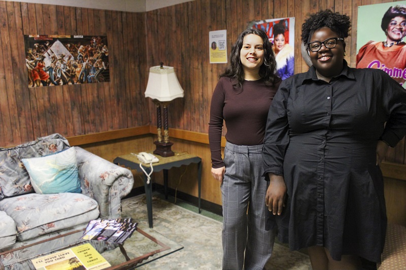 two women standing in a living room display